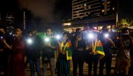 Demonstrators flash flashlights during a candlelight vigil after Sri Lankan police fired live ammunition, in Colombo, Sri Lanka, April 19, 2022. Reuters/Navesh Chitrakar