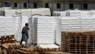 A laborer stands near the cargo supply at a warehouse near the port area in Karachi, Pakistan May 13, 2020. REUTERS/Akhtar Soomro/File Photo