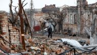 A man walks near damaged buildings in the course of Ukraine-Russia conflict in the southern port city of Mariupol, Ukraine April 22, 2022. REUTERS/Alexander Ermochenko


