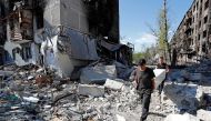 Local residents take furniture out of an apartment building heavily damaged during Ukraine-Russia conflict in the southern port city of Mariupol, Ukraine April 28, 2022. Picture taken April 28, 2022. REUTERS/Alexander Ermochenko


