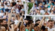 Real Madrid's Marcelo holds the trophy and celebrates with team members after winning LaLiga REUTERS/Susana Vera
