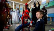 Argentine volunteer and member of the so-called Hero Club (Club de Heroes), Tomas Bensussan, who impersonates Spiderman, plays with the son of an inmate during a visit at the 33rd prison in Los Hornos as part of a wider program for vulnerable minors, on the outskirts of Buenos Aires, Argentina April 30, 2022. REUTERS/Agustin Marcarian