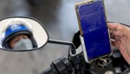 A motorcycle rider uses the PriceLOCQ app to refuel in a gas station in Muntinlupa, Metro Manila, Philippines April 7, 2022. Picture taken April 7, 2022. REUTERS/Eloisa Lopez