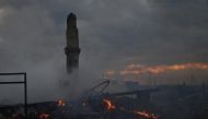 A view shows the ruins of a burned building in the town of Nazyvayevsk, as a state of emergency has been declared in the Omsk region due to wildfires, Russia May 6, 2022. REUTERS/Alexey Malgavko

