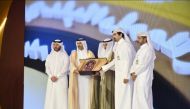 Assistant Undersecretary for Municipal Affairs at the Ministry of Municipality Mansour Abdullah Zaid Al Mahmoud receives the award during a ceremony. 
