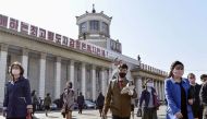 FILE PHOTO: People wearing protective face masks walk amid concerns over the new coronavirus disease (COVID-19) in front of Pyongyang Station in Pyongyang, North Korea April 27, 2020, in this photo released by Kyodo. Mandatory credit Kyodo/via REUTERS 