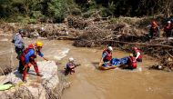A search and rescue team prepares to airlift a body from the Mzinyathi River after heavy rains caused flooding near Durban, South Africa, April 19, 2022. REUTERS/Rogan Ward/File Photo