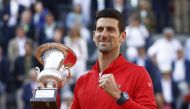 Serbia's Novak Djokovic celebrates with the trophy after winning the final against Greece's Stefanos Tsitsipas REUTERS/Guglielmo Mangiapane