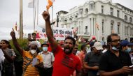 Anti-government demonstrators shout slogans during a protest demanding to arrest the supporters of the ruling party for storming an anti-government protest camp last week, outside the police headquarters, amid the country's economic crisis, in Colombo, Sri Lanka, May 16, 2022. REUTERS