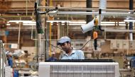 A worker assembles an air conditioner inside the Daikin Industries Ltd. plant at Neemrana in the desert Indian state of Rajasthan, October 1, 2014. REUTERS/Adnan Abidi/File Photo