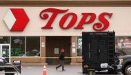 A Member of the FBI search for evidence at the scene of a weekend shooting at a Tops supermarket in Buffalo, New York, U.S. May 18, 2022. REUTERS/Brendan McDermid