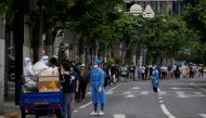 Residents line up for nucleic acid tests on a street during lockdown, amid the coronavirus disease (COVID-19) pandemic, in Shanghai, China, May 19, 2022. REUTERS/Aly Song
 