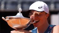 May 15, 2022 Poland's Iga Swiatek celebrates with the trophy after winning the Italian Open REUTERS/Guglielmo Mangiapane/File Photo