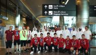 Qatar swimming team’s players and officials pose for a photograph on their arrival in Doha, yesterday. 