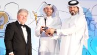 Tareq Hussain Al Khalaf, Director of the Public Relations & Communication Department, and Saif Jassim Al Kuwari, Director of National Product Competitiveness Support Department receiving the award.