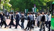People wear masks to prevent the spread of the coronavirus disease (COVID-19) as they walk on zebra crossing in Seoul, South Korea, May 3, 2022. REUTERS/ Heo Ran

