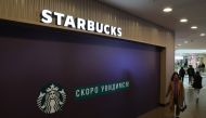 A woman walks past a closed Starbucks cafe in central Saint Petersburg, Russia May 23, 2022. REUTERS/Anton Vaganov
