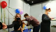 Eleven-year-old Chiara receives a dose of the Pfizer-BioNTech vaccine for children against the coronavirus disease (COVID-19) during a vaccination event for children at the Lanxess Arena in Cologne, Germany, December 18, 2021. REUTERS/Thilo Schmuelgen


