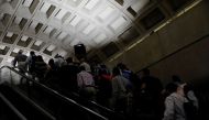Commuters ride an escalator during the morning rush at the Metro Center subway station in Washington, U.S. June 12, 2017. REUTERS/Jonathan Ernst

