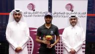 Abdulla Al Tamimi poses with the trophy along with Qatar Tennis, Squash, Badminton Federation Secretary General Tariq Zainal.