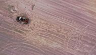 A military vehicle is pictured in a grain field previously mined with explosives, amid the Russian invasion of Ukraine, in Chernihiv region, Ukraine May 24, 2022. Picture taken with drone. REUTERS/Edgar Su/File Photo