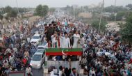 Ousted Pakistani Prime Minister Imran Khan gestures as he travels on a vehicle to lead a protest march in Islamabad, Pakistan May 26, 2022. REUTERS/Akhtar Soomro
