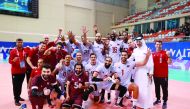 Qatar Volleyball Association President Ali bin Ghanem Al Kuwari celebrates with champion Al Annabi players and officials.
