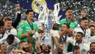 Real Madrid's Marcelo celebrates winning the champions league with the trophy and teammates REUTERS/Molly Darlington

