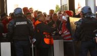 Fans, stewards and police officers at the turnstiles inside the stadium as the match is delayed REUTERS/Kai Pfaffenbach