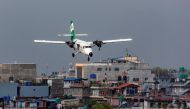 Tara Air's DHC-6 Twin Otter, tail number 9N-AET prepares to land at the airport of Pokhara, Nepal, April 11, 2022. Picture taken April 11, 2022. REUTERS/Nicolas Economou
