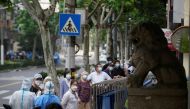 Residents line up for nucleic acid tests on a street during lockdown, amid the coronavirus disease (COVID-19) outbreak, in Shanghai, China, May 30, 2022. REUTERS/Aly Song