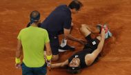 Germany's Alexander Zverev receives medical attention after sustaining an injury as Spain's Rafael Nadal looks on REUTERS/Gonzalo Fuentes
