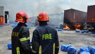 Firefighters work on the spot after a massive fire broke out in an inland container depot at Sitakund, near the port city Chittagong, Bangladesh, June 5, 2022. Reuters/Azim Aunon 