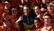 Spain's Rafael Nadal celebrates with the ball kids after winning the men's singles final against Norway's Casper Ruud REUTERS/Benoit Tessier