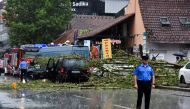 A fallen tree as a result of heavy rain and strong winds is seen downtown Pristina, Kosovo, June 6, 2022. REUTERS/Laura Hasani 
