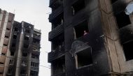 Resident Nataliia Prykhodko looks out from her burnt-out apartment in Irpin after coming back to Ukraine which she and her 17-year-old daughter left as refugees in February, outside Kyiv, as Russia's attacks on Ukraine continues, June 9, 2022. REUTERS/Marko Djurica 