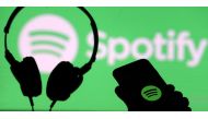 FILE PHOTO: A smartphone and a headset are seen in front of a screen projection of Spotify logo, in this picture illustration taken April 1, 2018. REUTERS/Dado Ruvic/Illustration/File Photo
