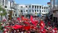 Demonstrators hold flags as they gather during a protest in opposition to a referendum on a new constitution called by President Kais Saied, in Tunis, Tunisia June 18, 2022. REUTERS/Jihed Abidellaoui