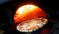 Pizza Margherita is prepared in a wood-fired oven at L'Antica Pizzeria da Michele in Naples, Italy. Reuters/Ciro De Luca/File Photo