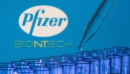 FILE PHOTO: Test tubes are seen in front of displayed Pfizer and Biontech logos in this illustration taken, May 21, 2021. REUTERS/Dado Ruvic/Illustration