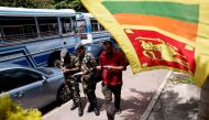Sri Lanka's Air Force members distribute tokens to people queueing for fuel amid the country's economic crisis, in Colombo, Sri Lanka, on June 27, 2022. (Reuters/Dinuka Liyanawatte)