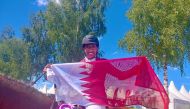 Qatari rider Saad Ahmed Al Saad celebrates after finishing fourth in the event.
