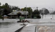 Debris is seen as the Windsor Bridge is submerged under floodwater from the swollen Hawkesbury River in Windsor, north west of Sydney, Australia, July 4, 2022. AAP Image/Bianca De Marchi via REUTERS