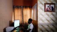 Victor Daniel, 26, a Nigerian coder who created the first African football game, Vikseen Virtual, plays the game in his home in Ogun State, Nigeria, June 23, 2022. REUTERS/Temilade Adelaja