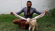 Mohammad Hassan Narejo, 30, displays Simba, a one month and four days old kid goat with 22-inch long ears, at his house in Karachi, Pakistan July 8, 2022. REUTERS/Akhtar Soomro