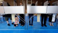 Voters prepare to cast their ballots in the upper house election at a polling station in Tokyo, Japan July 10, 2022. REUTERS/Issei Kato