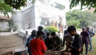 People cook in the garden of the Prime Minister's residence on the following day after demonstrators entered the building, amid the country's economic crisis, in Colombo, Sri Lanka July 10, 2022. (Reuters/Dinuka Liyanawatte)