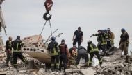 Rescuers extract a body from a residential building damaged by a Russian military strike, amid Russia's invasion of Ukraine, in the town of Chasiv Yar, in Donetsk region, Ukraine July 10, 2022. REUTERS/Gleb Garanich

