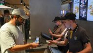 A customer pays for a meal at the new restaurant 