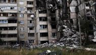 A book is seen on a playground in front of a building destroyed by a military strike, as Russia's invasion of Ukraine continues, in northern Saltivka, in Kharkiv, Ukraine, July 13, 2022. (REUTERS/Nacho Doce)